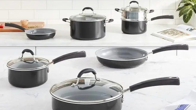 An assortment of Cuisinart pots and pans on a countertop.