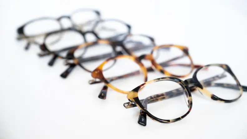 An image of 5 eyeglasses laid out in a row.
