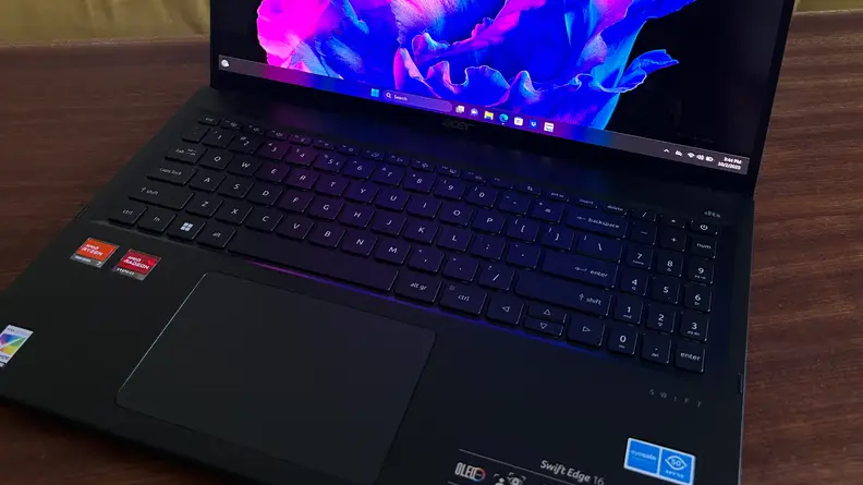 A mid-shot of a laptop keyboard and part of its display.