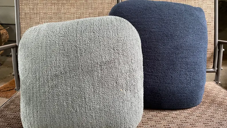 Two grey and navy-blue Quiet Mind Weighted Pillows side-by-side.