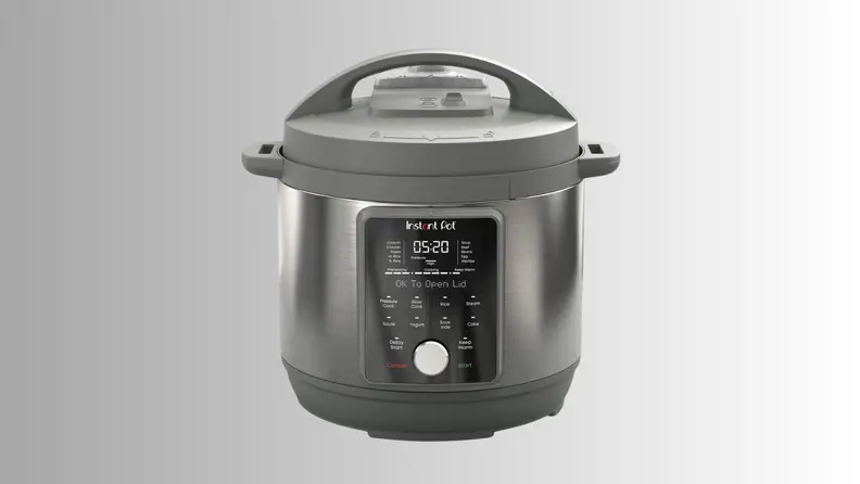 An Instant Pot cooker sits on a gray ombre background