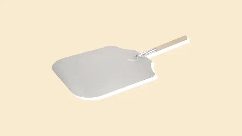 A pizza spatula on a beige background.