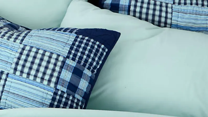 land's end flannel sheets on a bed with a navy patchwork quilt