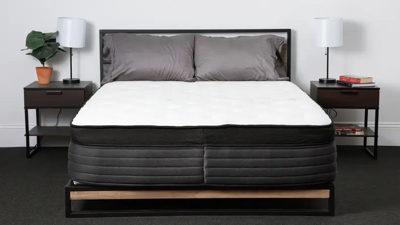 The Nolah Evolution mattress in a bedroom with bedside tables on either side.