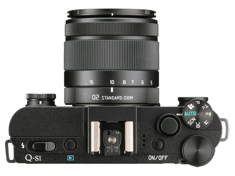 The Pentax Q-S1 retains the pop-out flash, hot shoe, and top plate control cluster from the Q7.