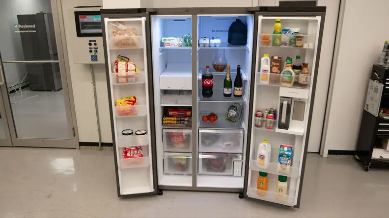 Samsung RS28CB7600 side-by-side Bespoke refrigerator with both doors open to reveal assorted foods on each shelf and inside of both doors.