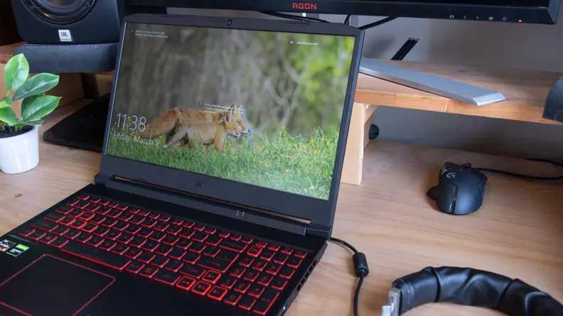 The laptop shows a fox on the screen