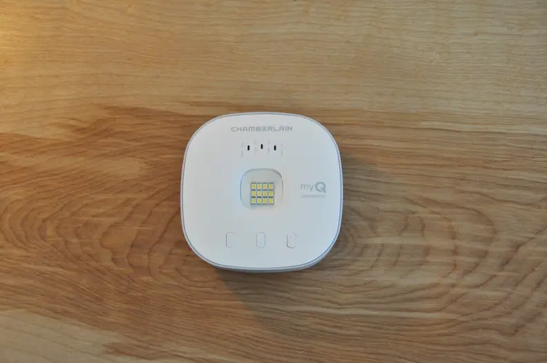 an uninstalled smart garage door opener sits on a table