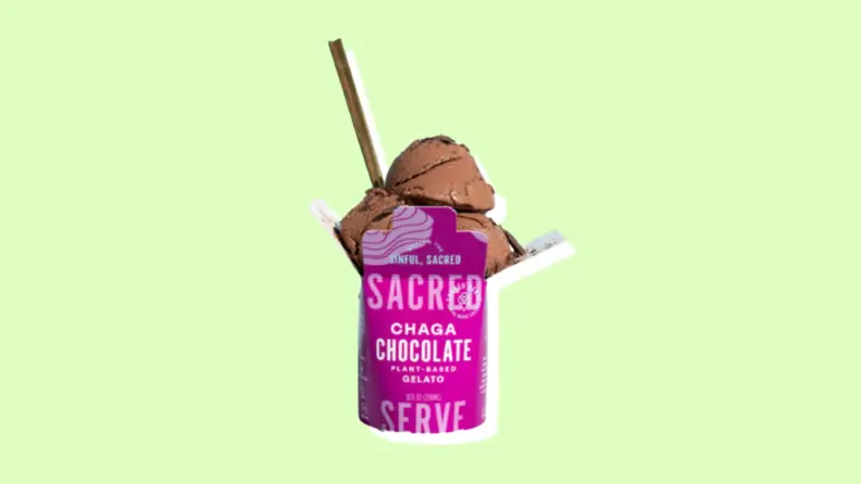 A pink and white container of Scared's Chaga Chocolate plant-based gelato with a lime/yellow background.