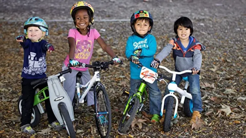 A line of kids on their bikes wearing ZippyRooz gloves