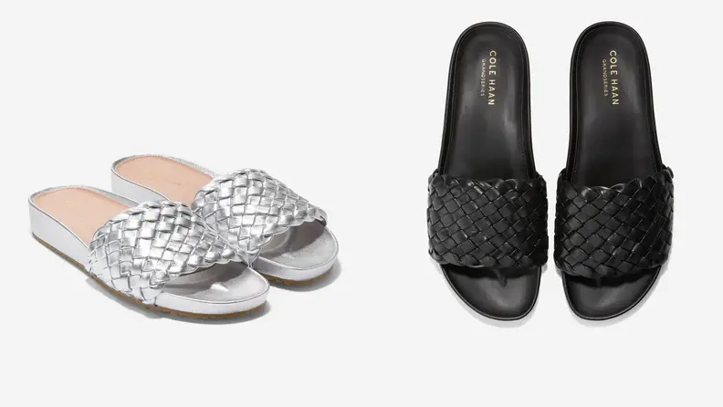 Silver and black slide sandals on grey background