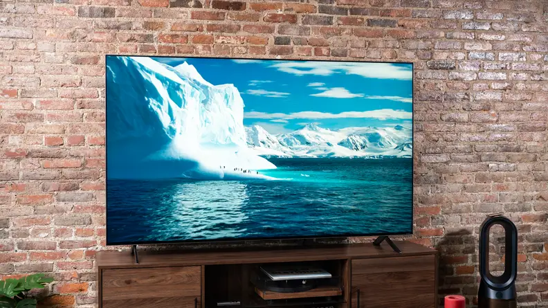The 8K LG QNED99 displaying 4K content in a living room setting