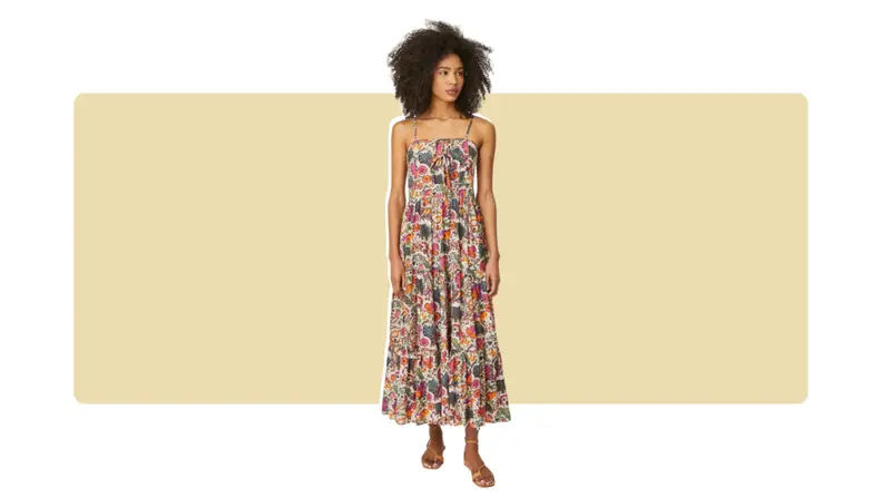A midi-length casual dress with a floral print all over. There are simple lace bow-ties in front.