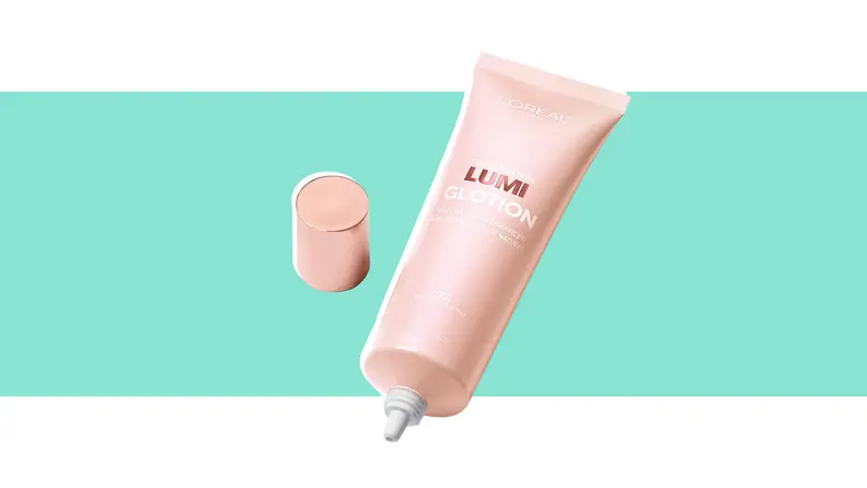 A tube of lotion against a green background.
