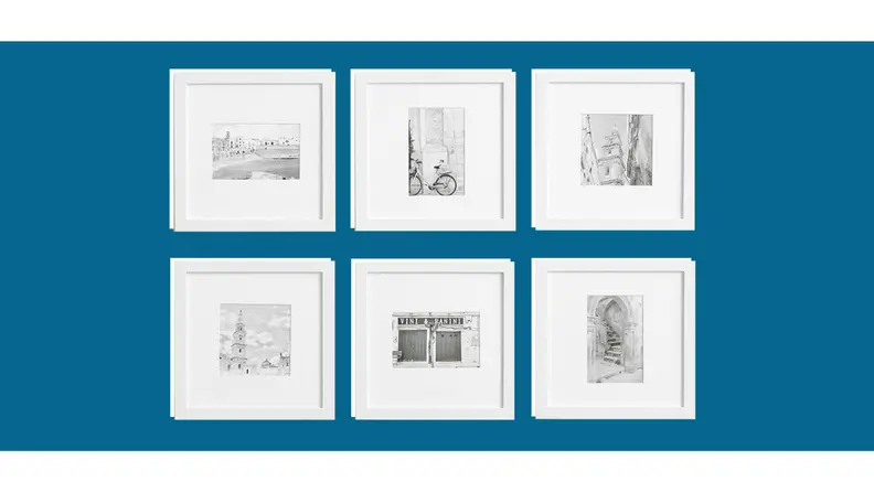 A wall filled with art frames.