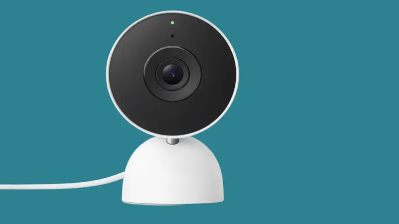 A white security camera on a teal background