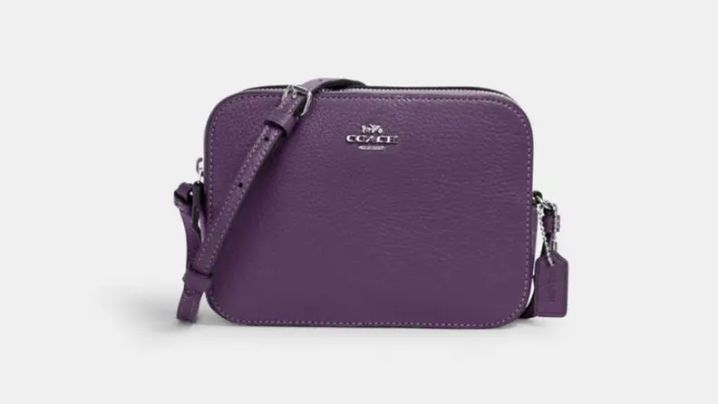 A purple Coach bag against a white background.