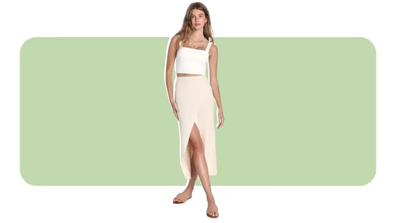 A model wearing a cream-colored textural skirt with a fishtail front