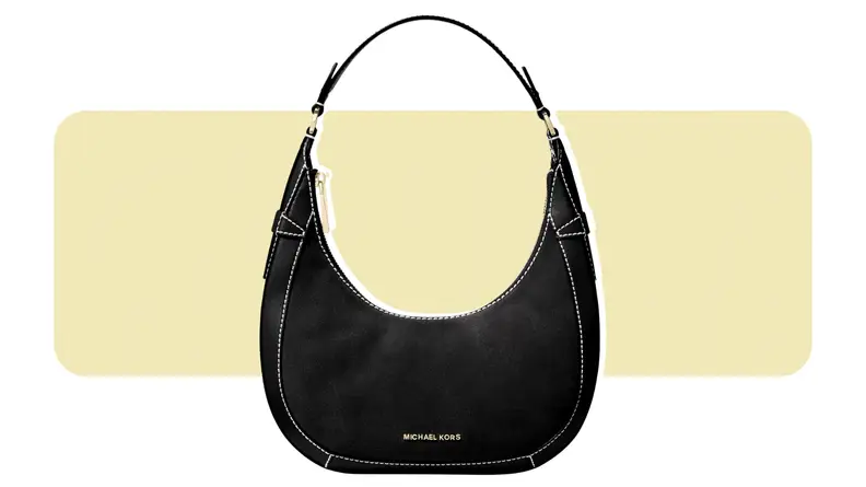 A crescent-shaped suede handbag.