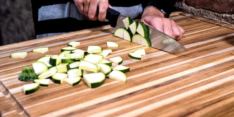 A sturdy wooden cutting board like the Teakhaus Carving Board provides a solid foundation for turkey carving.