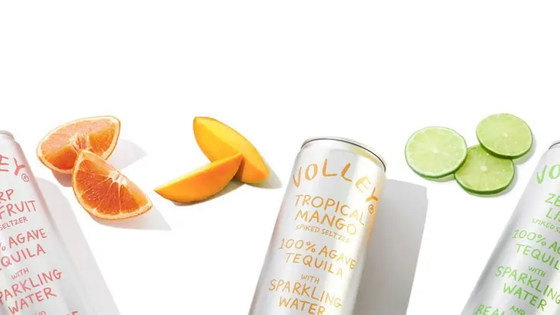 Assorted hard seltzer cans against a white background.