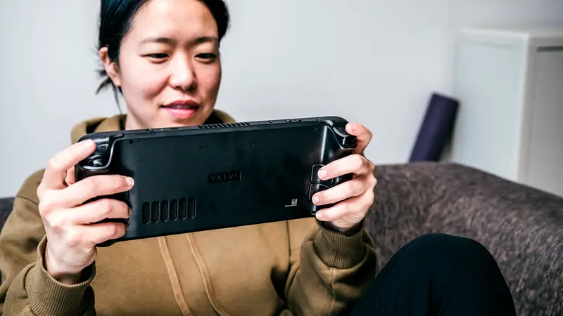 Woman using a handheld video game console