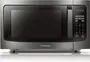 A pair of stainless-steel microwaves sit side by side on a wood-grain countertop.
