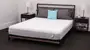a woman lies down on a stack of mattresses reading