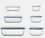 Several food strage containers filled with fresh produce on a wooden surface