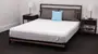 a woman lies down on a stack of mattresses reading