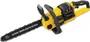 Six chainsaws sitting on the ground outside near a tree stump