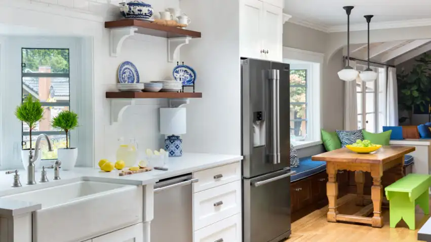 This kitchen, by Maria Killam, includes white subway tile and open shelving.
