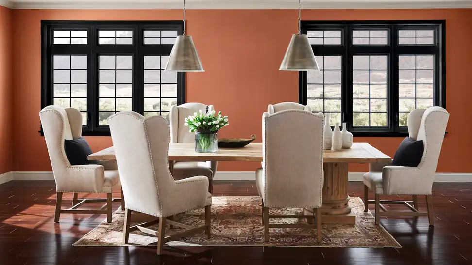 This picture shows two of 2019's trends: black windows and Sherwin-Williams Cavern Clay walls.