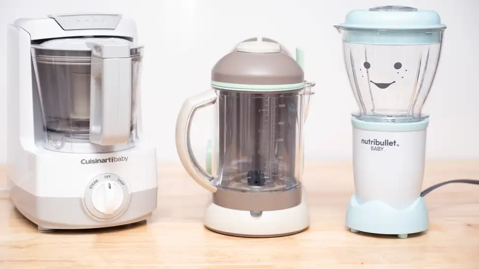 Three different baby food makers sit on a kitchen counter.