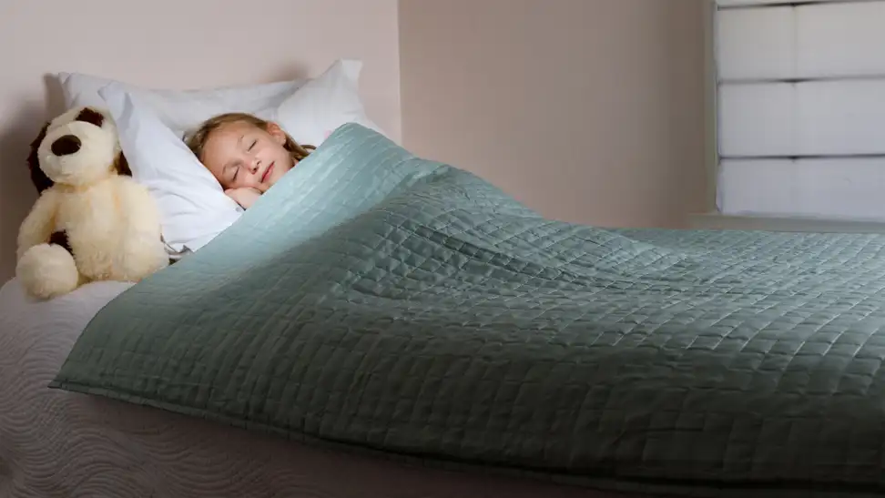 Girls sleeping under gravity blanket