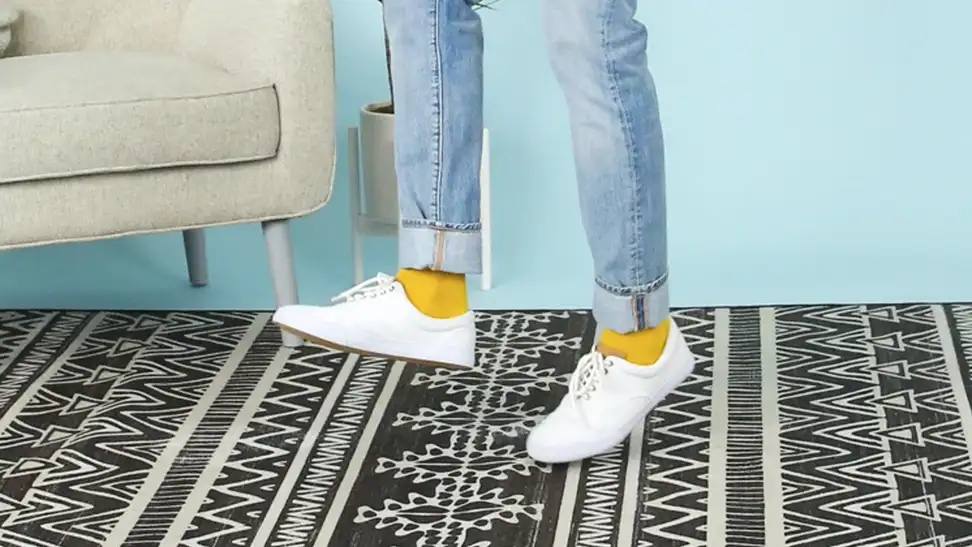 Someone standing on a geometric rug