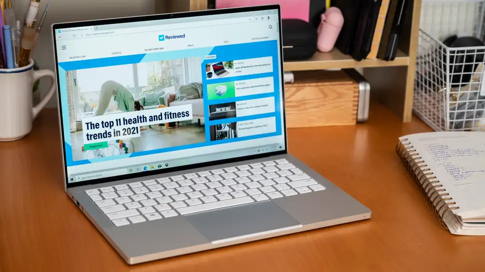 The laptop is on a desk, its bright screen the focus of the image.