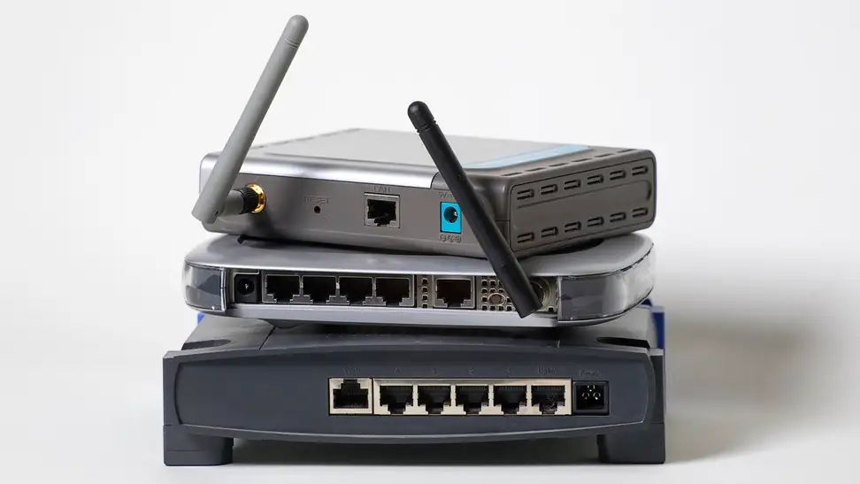 A number of wireless routers, stacked on top of one another.