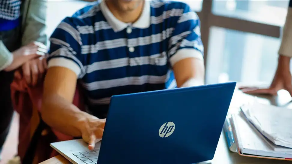 Man typing on HP laptop