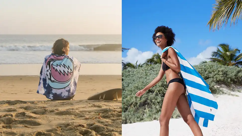 Person on a beach wrapped in a Grateful Dead towel / Person walking on beach with blue and white striped towel hanging from their shoulder.