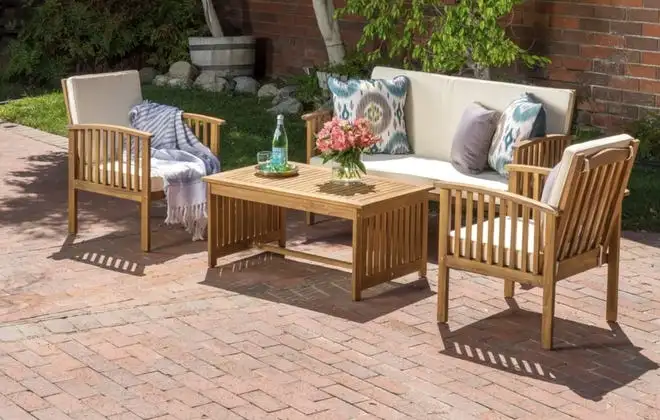 Brick patio with light wooden furniture with white cushions