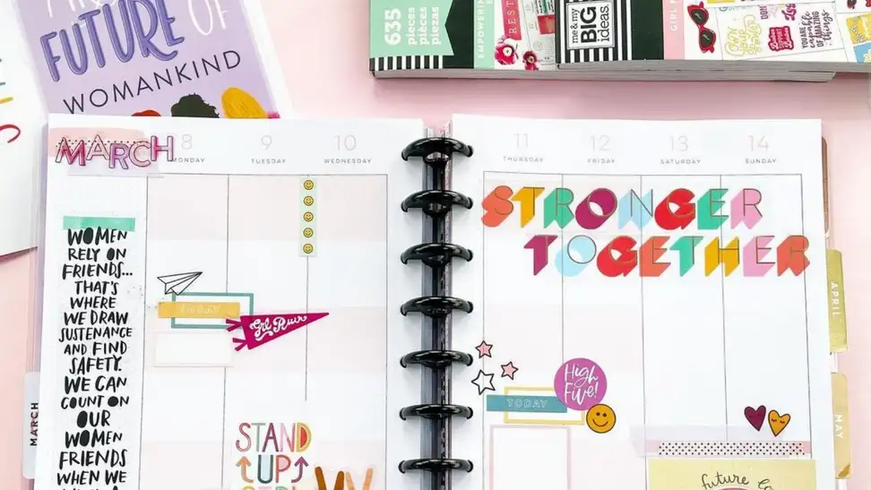 A colorful planner from Happy Planner with stickers.