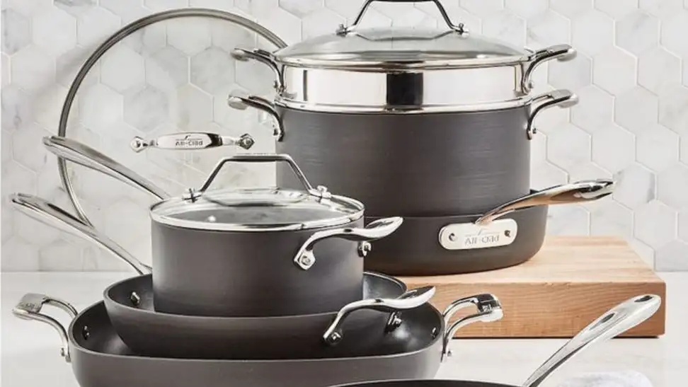 Set of slate gray All-Clad cookware set on countertop.