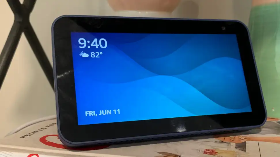 Amazon's Echo Show 5 (second-gen) smart display sits on a bookshelf.