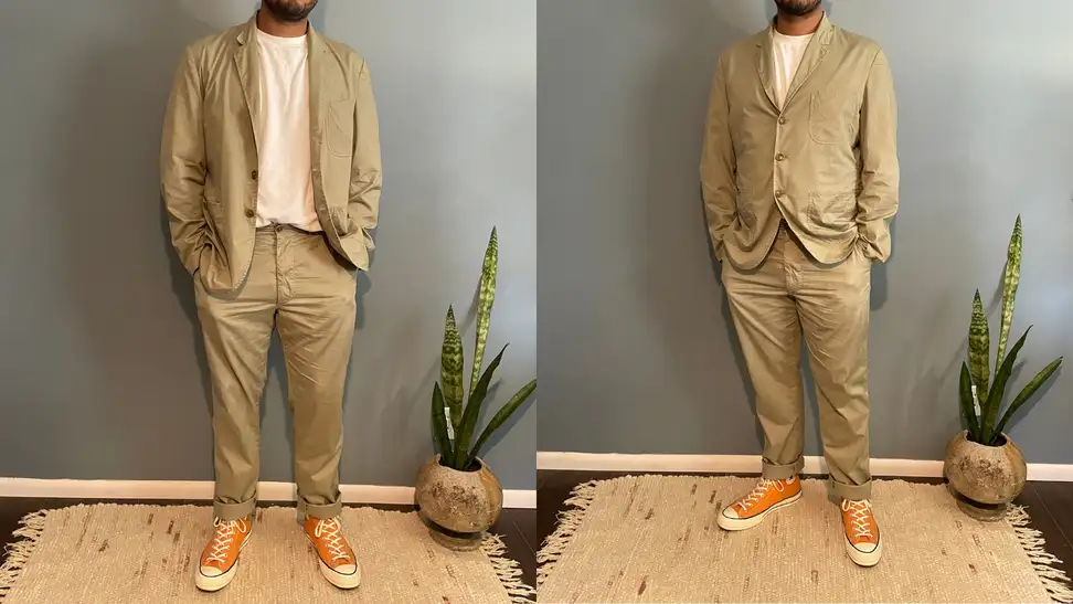 man with hands inside pockets wearing Buck Mason Carry-On Suit and orange Chuck Taylors