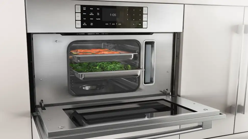 A wall oven with its door open revealing steamed foods.