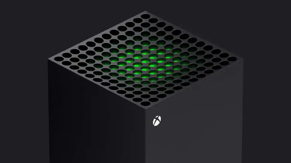 The top of a gaming console with a glowing green center