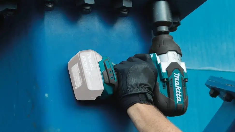 Man using a power wrench.