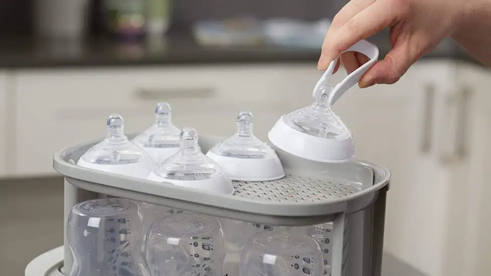 Bottles being sterilized in a bottle sterilizer.