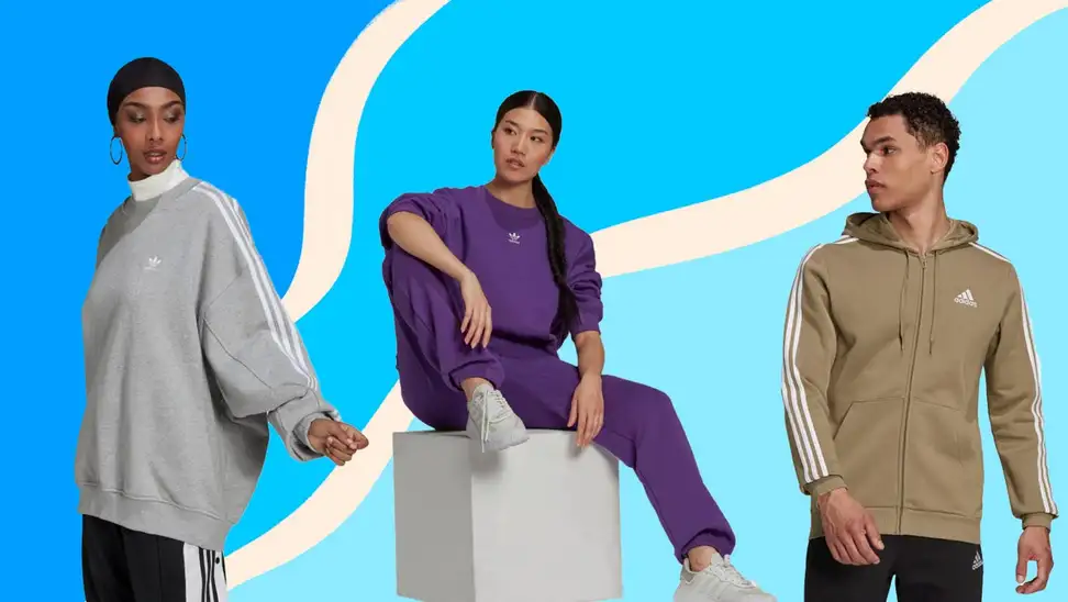 Three people wear Adidas athleisure against a blue background.
